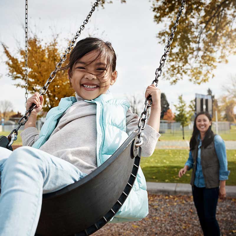 Girl smiling on swing